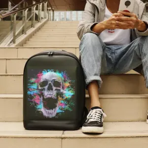 Black programmable LED backpack with full-color dynamic skull screen display worn outdoors